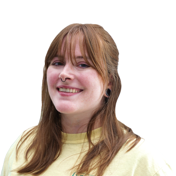 Headshot of a smiling woman, long reddish hair with bangs.